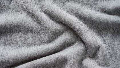 Gray color plush fabric background texture, wrinkled on the table, background pattern of soft warm material, cozy winter concept; close up selective focus image