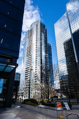 Modern city canyon, high rise cityscape of a modern downtown, glass residential and commercial...