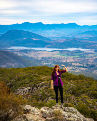 hiker girl admiring the panorama of mountains on the way to the top of mount maroon, mount barney...