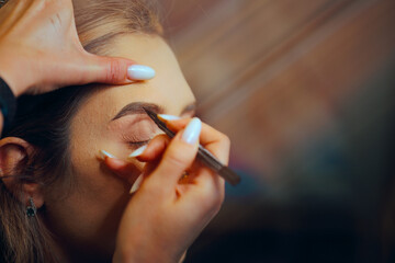 Woman Having Her Eyebrows Done with a Gel Pencil. Client having her brows redefined by a...