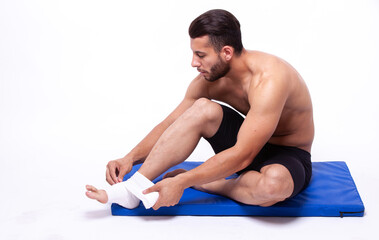 Sports guy with elastic bandage on his leg - 749681211
