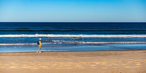 beautiful girl walking on the sand dunes in north bribie island near caloundra, sunshine coast,...