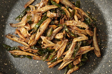 Delicious salted fish stir-fry with green chilies, perfect with warm white rice, each bite a...