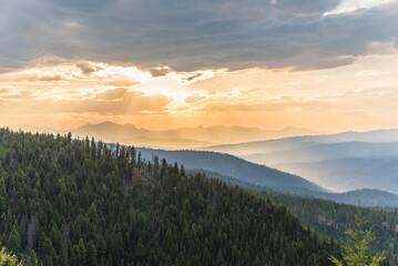 Sunlight Shining Over Distant Jagged Peaks