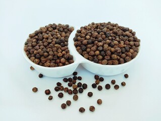 Black peppercorn seeds in a bowl blackpepper whole seed grains  hot indian spice natural food...