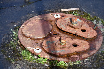 Old rusted light post foundation.
