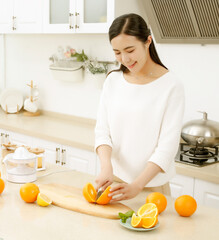 Making juice in the kitchen. Asia. Mothermaking juice together.