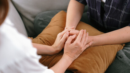 Supportive and comforting hands cheering up depressed patient person or stressed mind with prim...