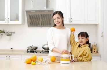 Asian mother making fresh juice with her daughter