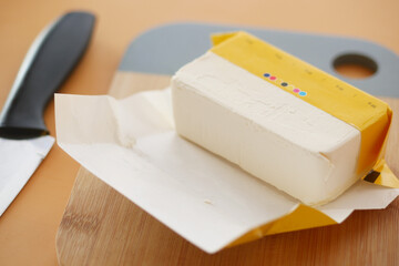 slice of a butter on a paper on table 
