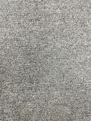 Seamless close up of monochrome grey carpet texture background from above.