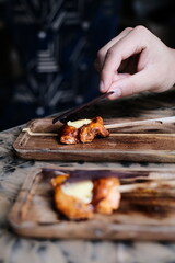 Chicken skewers with sauce on a plate over a light grey slate, stone or concrete background. in Hong Kong fine diningrestaurant	
