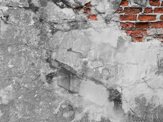Old wall background with bricks and damaged plaster