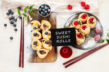 Asian sweet sushi pancake. Rolls with cream cheese berry and fruits.