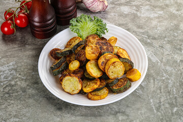 Roasted young zucchini in the plate