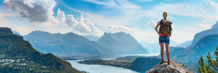 Photo sur Aluminium Europe du nord Banner of woman tourist standing on top of a rock and enjoying fascinating view with mountains and lakes around
