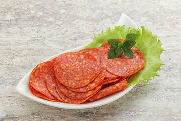 Sliced pepperoni sausage in the bowl