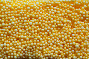 close up of yellow foam beads for the background