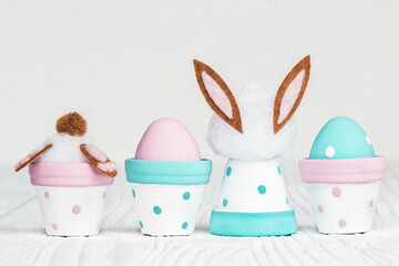 Cute Easter decorations, flowerpots and handmade Easter eggs in pastel colors