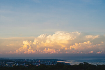 Seascape nature beauty, magic huge cumulus pink orange clouds over blue sea, freedom happiness opportunity