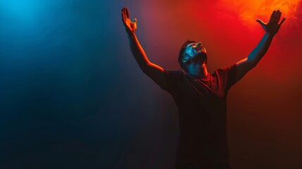 A Christian man praying to God crying and emotional with his arms raised