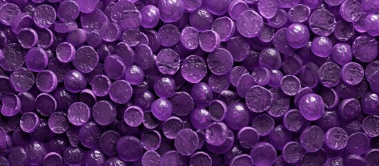 A detailed view of a bold purple background filled with a multitude of circular shapes in various sizes. The circles are tightly packed, creating a visually striking and vibrant texture.