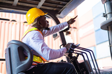 Engineer loads goods by forklift to stack containers