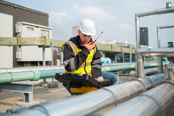 Technician Using Measuring Equipment on Industrial Pipes