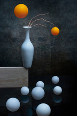 Still life with white and orange balls and white vase