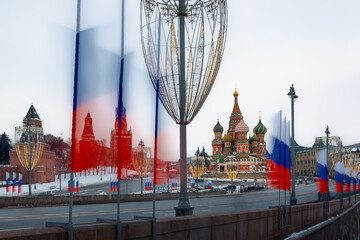 Kremlin and St Basil Cathedral with flags of Russian Federation along street at winter, Moscow,...