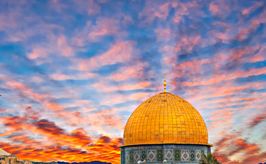 Dramatic sunrise above golden dome of Rock Mosque on Temple Mount in old city of Jerusalem, the image may be used for major Islamic holiday of Ramadan - 749788004