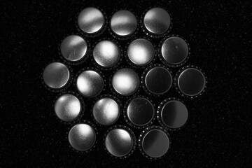 Beer bottle caps on different backgrounds.