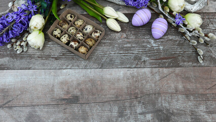 Obraz na płótnie Canvas Easter decoration with flowers on shabby wooden board with space for text.