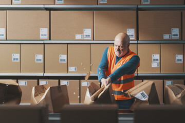 Angry rebellious worker smashing boxes on the conveyor belt