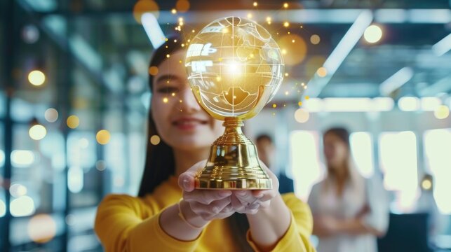 A woman holding a golden trophy. Suitable for victory and success concepts