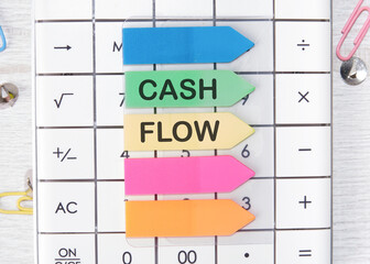 Cash flow text written on arrow-shaped stickers