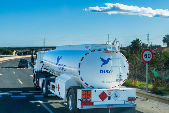 Motril,Granada, 2,27,2024; Single-axle fuel tanker truck from the Disa oil company traveling on the highway, rear view.