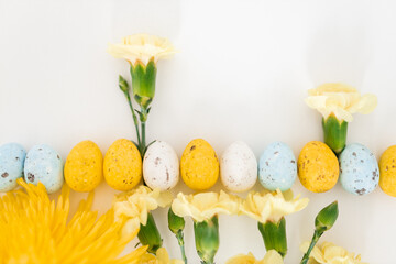 Yellow and white colored eggs and yellow flowers on a white background. Food on a clear white background. Mockups. Layout. Easter minimalist background
