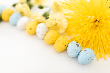 Yellow and white colored eggs and yellow flowers on a white background. Food on a clear white background. Mockups. Layout. Easter minimalist background
