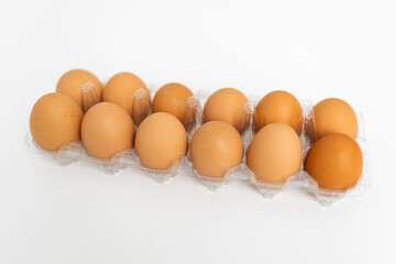 Large brown organic eggs with pink flowers. Food on a clear white background. Mockups. Layout.
