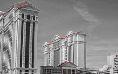 Neon signs, glitz casino hotel resorts, traffic and highrise city skyline in superlative gambling...
