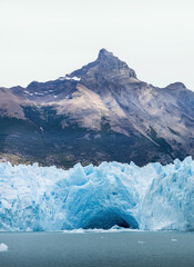 Majestic Glacier Front with Icy Cavern and Mountain Peaks