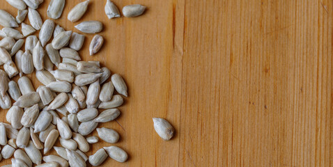 Sunflower seeds on wooden surface close-up, view from above