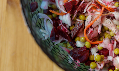 Colorful vegetable salad in a glass bowl, view from above, close-up, macro
