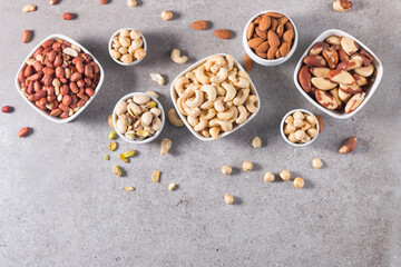 Healthy mix nuts and dried fruits on wooden background. Almonds, hazelnuts, cashews, peanuts, pistachios, Brazilian nuts