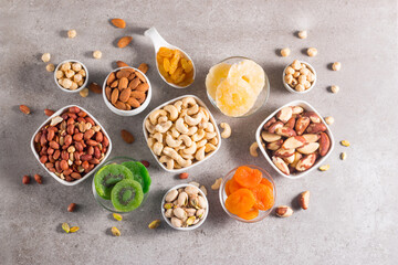 Healthy mix nuts and dried fruits on wooden background. Almonds, hazelnuts, cashews, peanuts, pistachios, Brazilian nuts