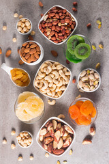 Healthy mix nuts and dried fruits on wooden background. Almonds, hazelnuts, cashews, peanuts, pistachios, Brazilian nuts