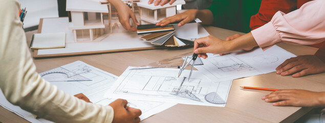 Professional architect team select sustainable house materials while skilled engineer using divider measure blueprint with house model and color palette placed on meeting table. Closeup. Variegated. - obrazy, fototapety, plakaty