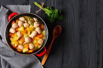 finnish sausage soup with vegetables in red pot