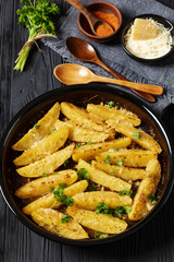 greek lemon potatoes with garlic, cheese on dish